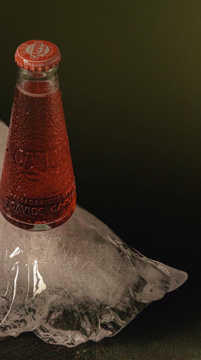 Chilled Campari soda bottle placed on ice, reflecting Italian aperitif culture.