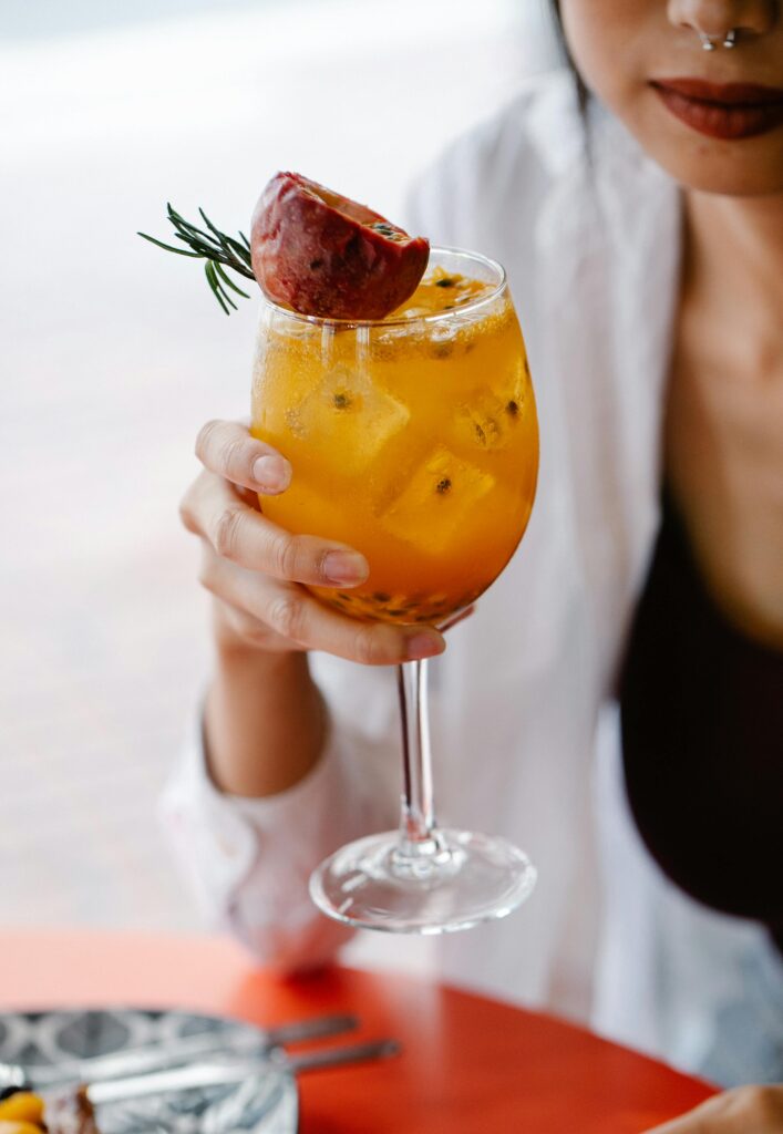 pexels photo 8679068 8679068 Vibrant citrus cocktail with pomegranate and rosemary garnish, perfect for a refreshing drink.